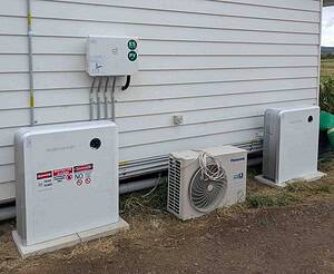 SidEnergy battery system, solar inverter, and Panasonic heat pump units installed outside weatherboard home