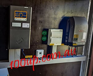 Wall-mounted solar inverters and battery system components in off-grid installation with monitoring display