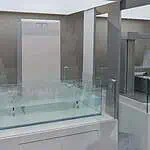 White battery unit displayed in glass case in modern showroom with Chinese and English signage