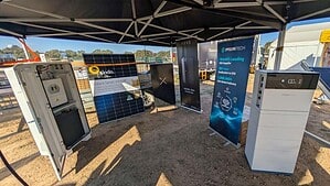 Trade show display featuring Pylontech battery systems, solar panels, and energy storage equipment under marquee tent