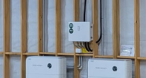 Sigenergy Gateway switchboard mounted on timber frame wall with two battery units below during off-grid solar installation