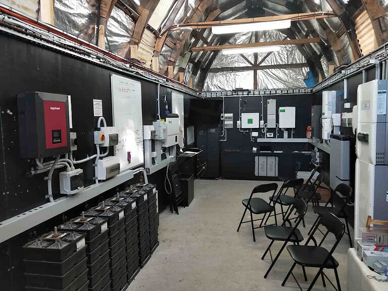 Interior of Smart Energy Lab training facility showing inverters, battery systems and educational displays at Mount Toolebewong
