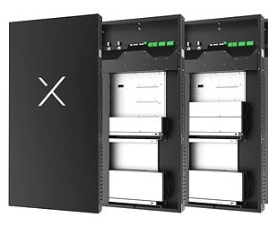 XESS off-grid battery cabinet system with door open showing white battery modules and green connection terminals