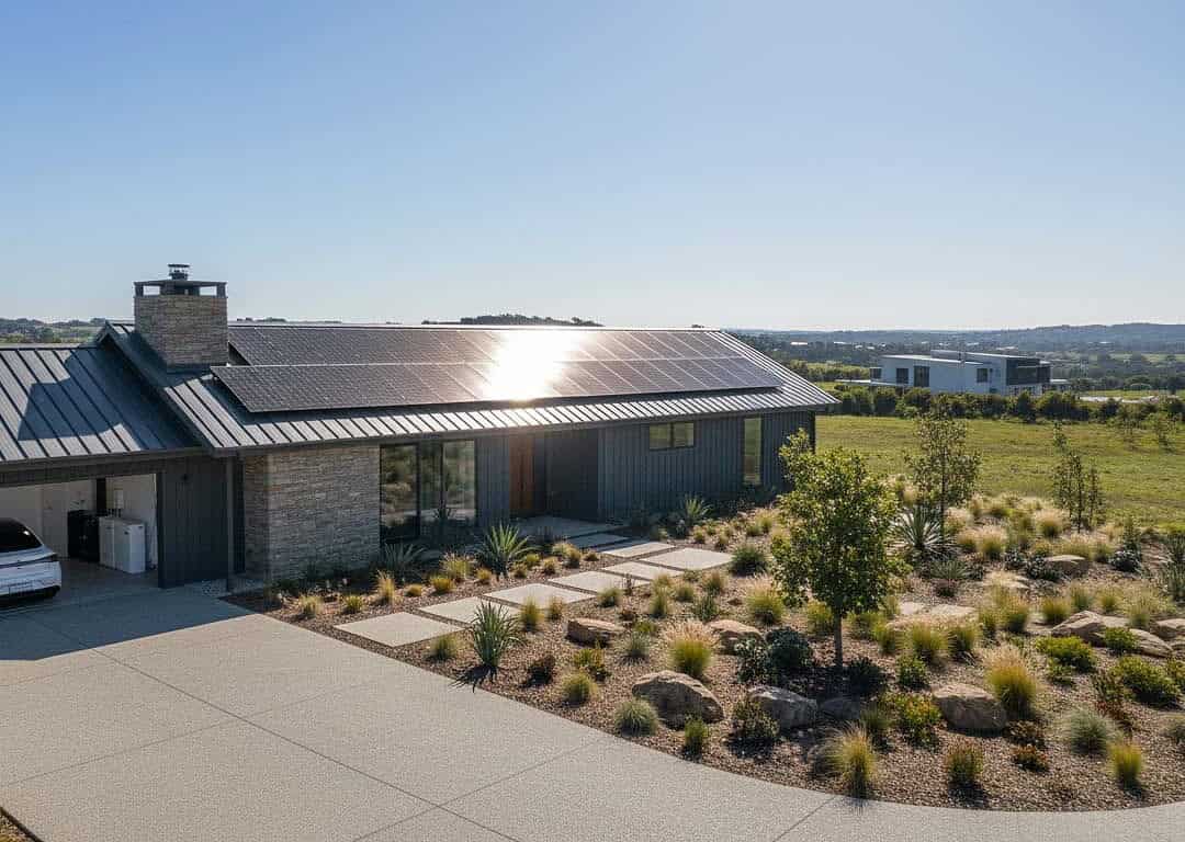 Modern off-grid home with rooftop solar array, battery storage and EV charger