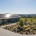 Modern off-grid home with rooftop solar array, battery storage and EV charger
