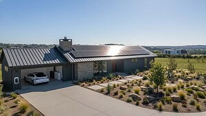 Modern off-grid home with rooftop solar array, battery storage and EV charger